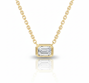 Gold necklace with a diamond pendant on a white background