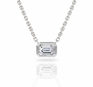 Diamond necklace with emerald-cut pendant on a white background