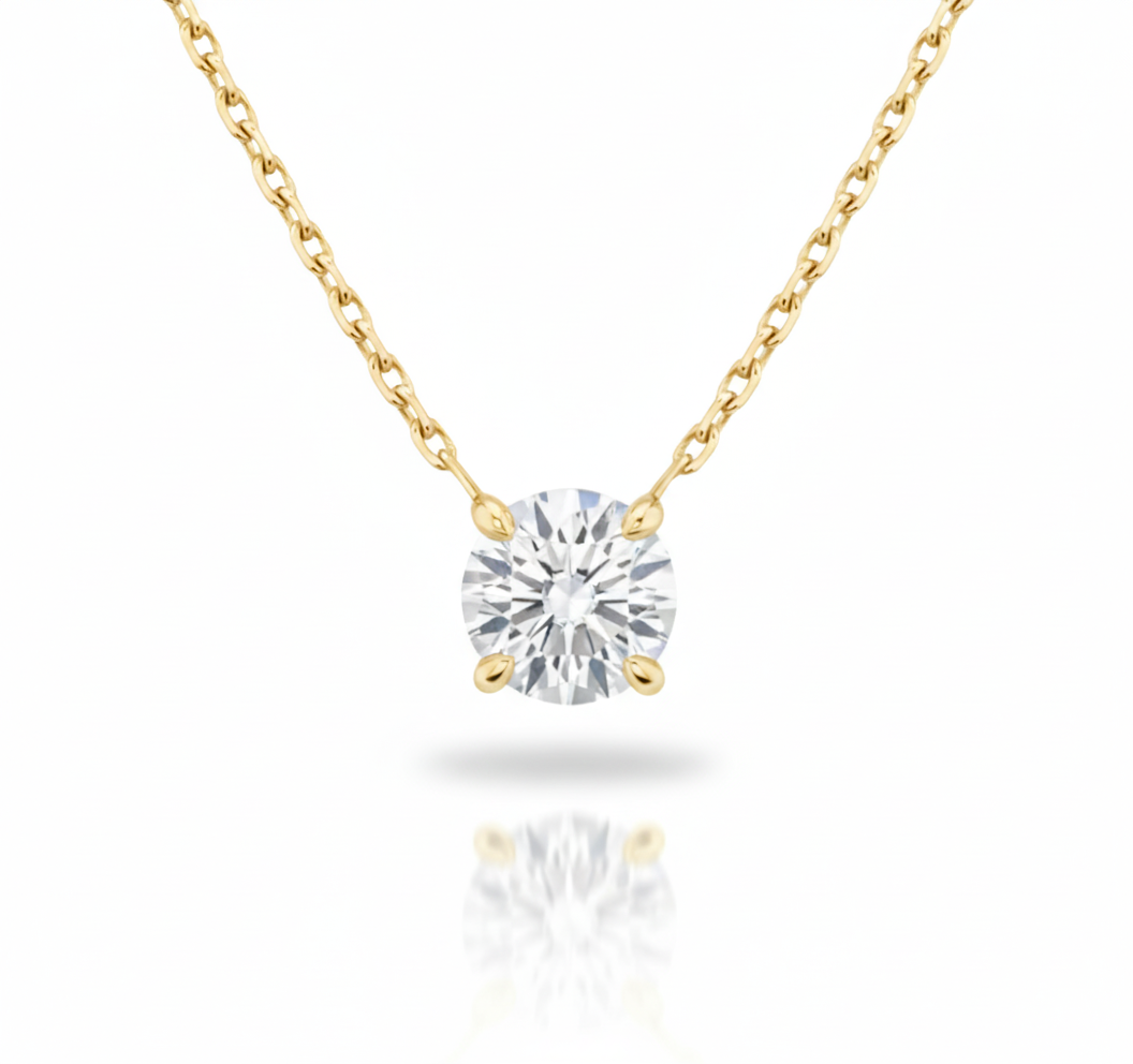 Gold necklace with a round diamond pendant on a white background