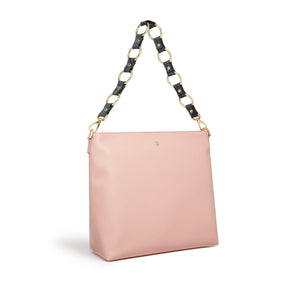 Pink handbag with a unique handle design on a white background