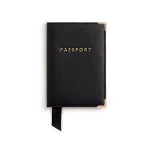 Black passport holder with gold text on a white background