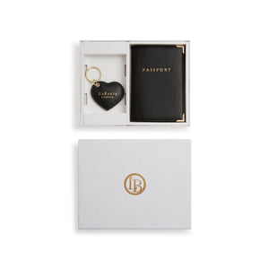 Black passport and heart-shaped keychain in a white box with 'Labante London' branding.