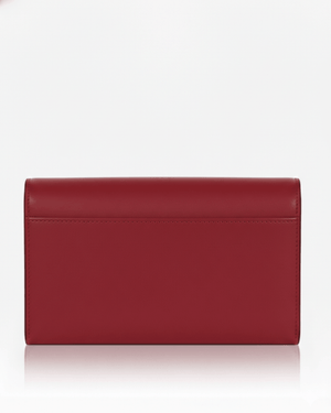 Black clutch bag with gold zipper on a white background