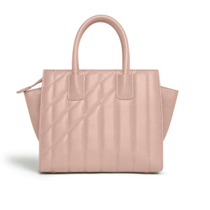 Pink quilted handbag on a white background