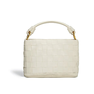 White woven handbag with gold handle on a white background