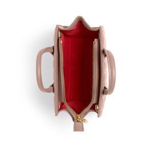 Pink handbag with a red interior on a white background