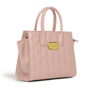 Pink quilted handbag with a gold tag on a white background