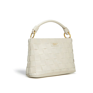 White textured handbag with gold accents on a white background