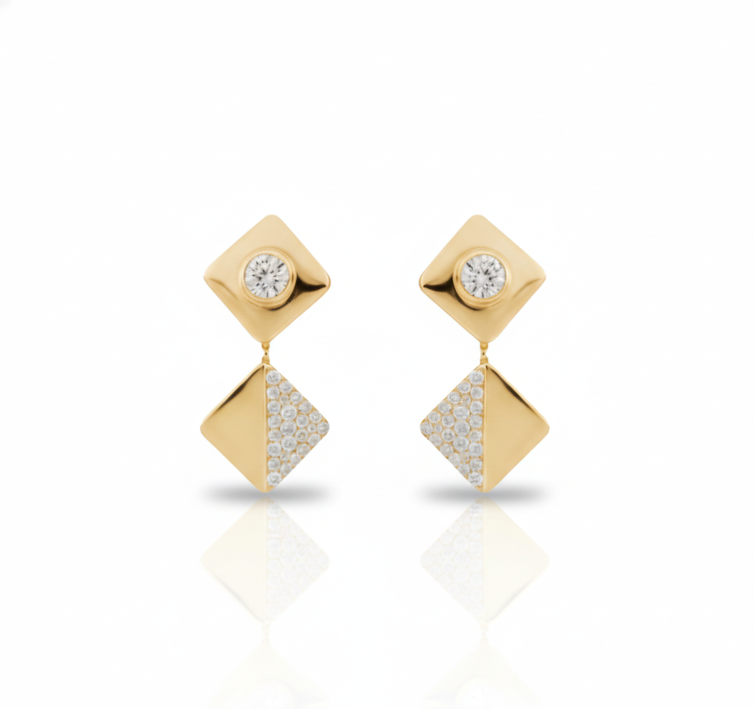 Gold earrings with diamond-like stones on a white background