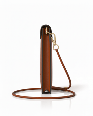 Brown leather handbag with a strap on a white background
