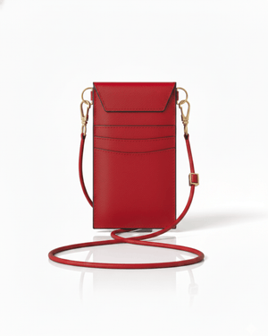 Red leather crossbody bag with a strap on a white background