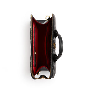 Black leather handbag with gold accents on a white background
