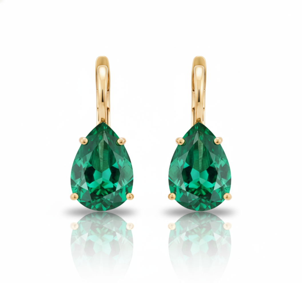Gold earrings with green teardrop-shaped gemstones on a white background