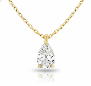 Gold necklace with a pear-shaped diamond pendant on a white background