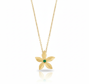 Gold flower-shaped necklace with a green gemstone on a white background