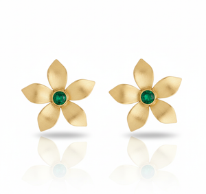 Gold flower-shaped earrings with green gemstones on a white background