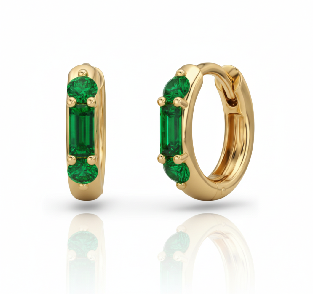 Gold hoop earrings with green gemstones on a white background