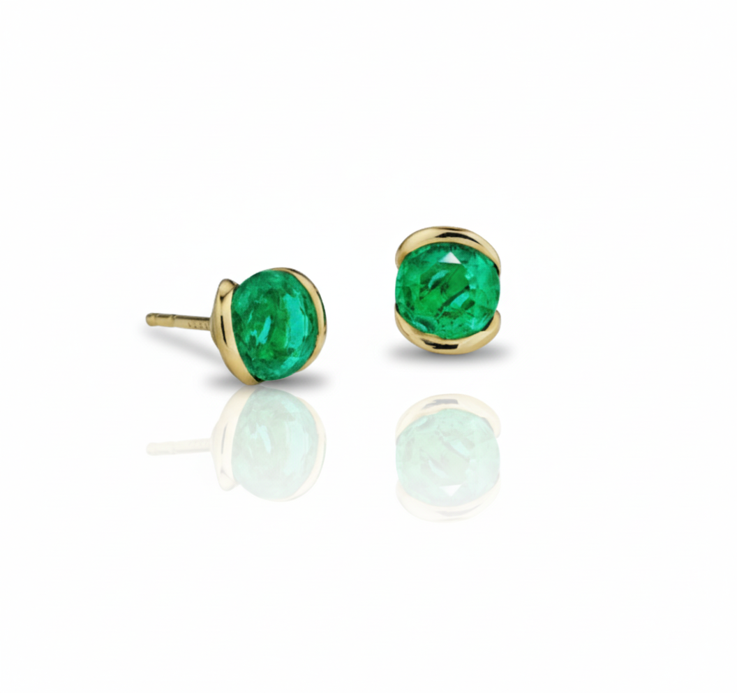 Gold earrings with green gemstones on a white background