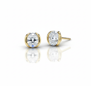 Gold stud earrings with clear gemstones on a white background