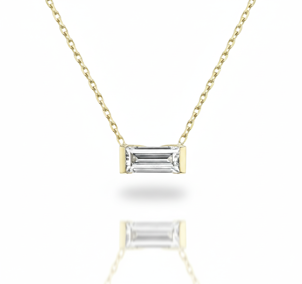 Gold necklace with a rectangular diamond pendant on a white background