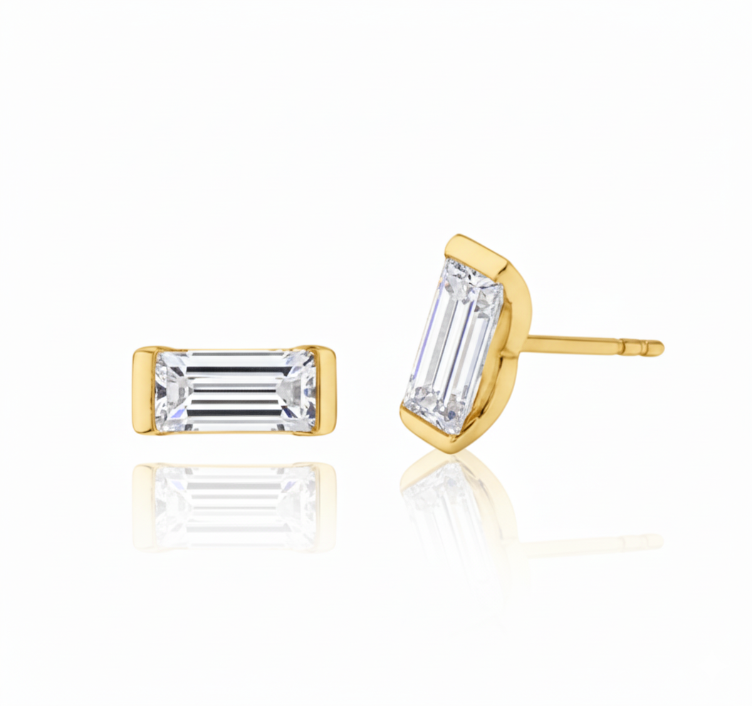 Gold stud earrings with baguette-cut gemstones on a white background