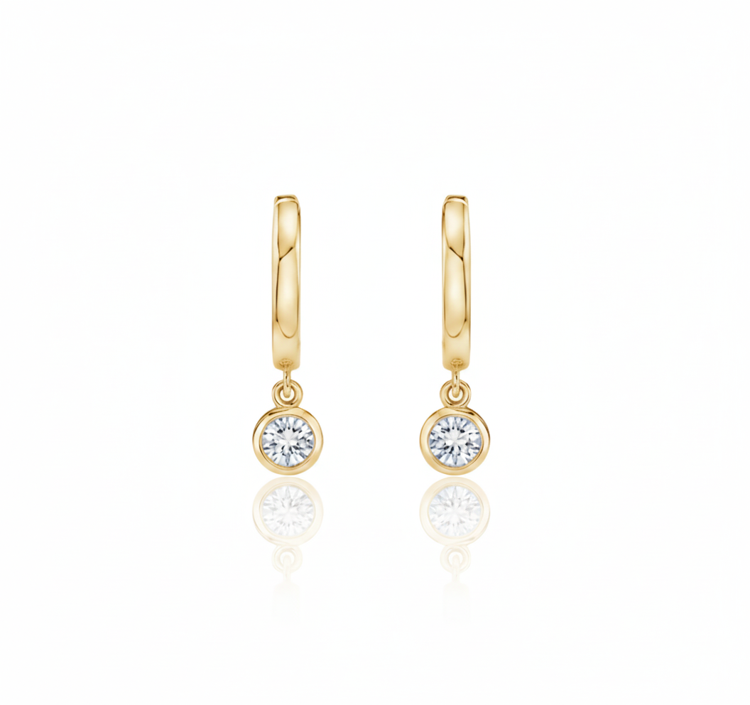 Gold hoop earrings with round gemstones on a white background