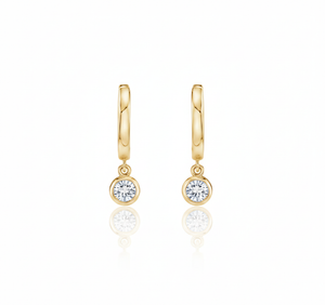 Gold hoop earrings with round gemstones on a white background