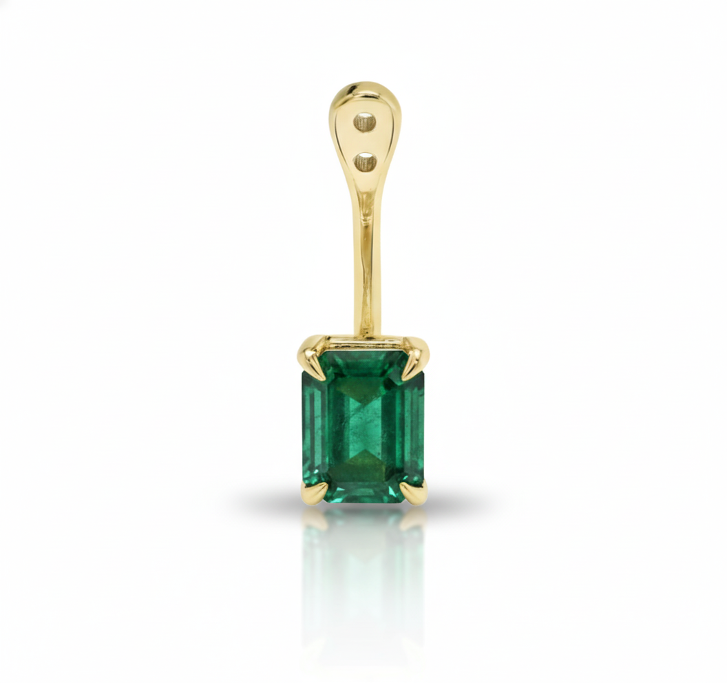 Gold pendant with a green gemstone on a white background