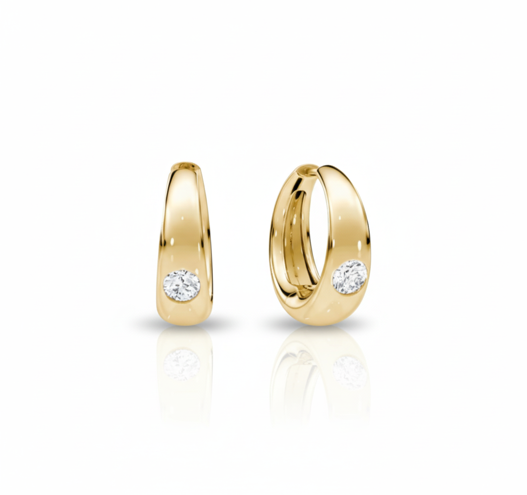 Gold hoop earrings with embedded diamonds on a white background