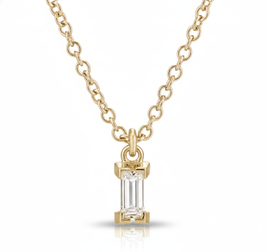 Gold necklace with a diamond pendant on a white background
