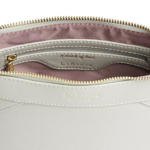 Close-up of a light gray handbag with a gold zipper, showing the brand 'La Canasta' on a white background.