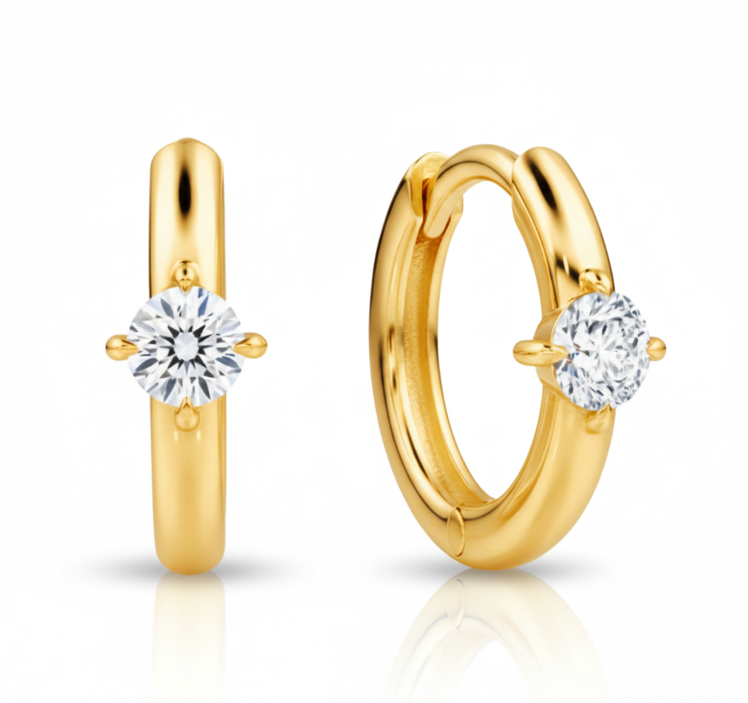 Gold hoop earrings with clear gemstones on a white background