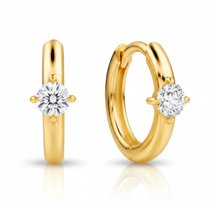 Gold hoop earrings with clear gemstones on a white background