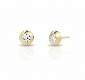 Gold stud earrings with clear gemstones on a white background