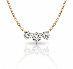 Rose gold necklace with three diamond-like stones on a white background