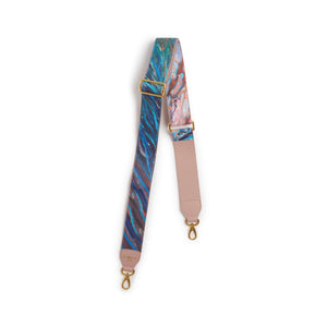 Marbled patterned strap with gold hardware on a white background